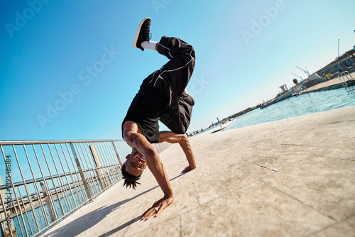 Obraz na płótnie Breakdancer performing handstand freeze pose outdoors