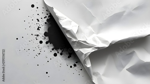 Crumpled white paper revealing dark ink splatters and halftone texture.