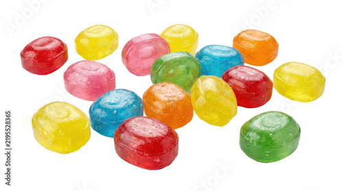 Assorted translucent hard candies scattered across clean surface captured bright studio photography isolated white background