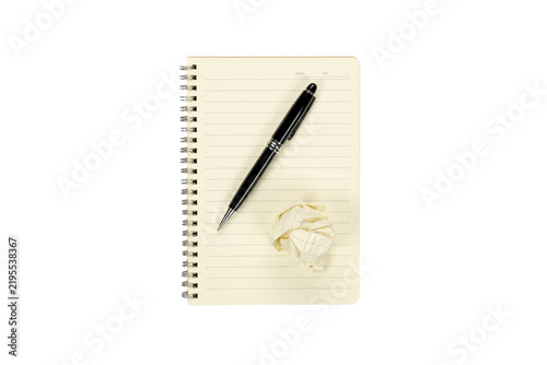 Black pen and crumpled paper ball on blank spiral notebook isolated on white background with clipping path