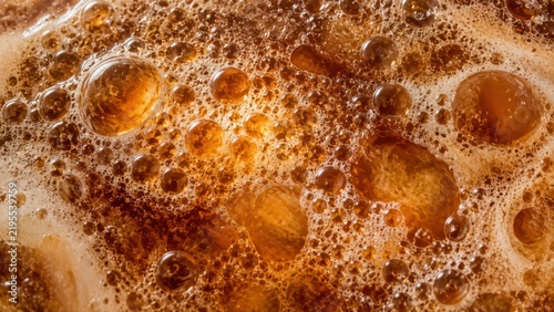 Fermentation foam in macro view, amber bubbles, fine frothy microcells and translucent spherical pockets. Scientific texture background for design. For science media and editorial publishing.