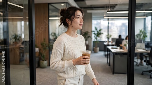 Asian Businesswoman Walking Through Modern Office with Iced Coffee