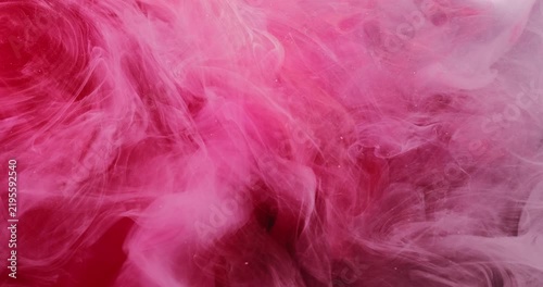 Color mist. Red paint. Defocused pink underwater vapor liquid glitter water bright texture spreading on abstract vibrant art background.