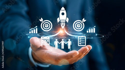 Businessman Holding Holographic Business Icons and Rocket Launch for Startup