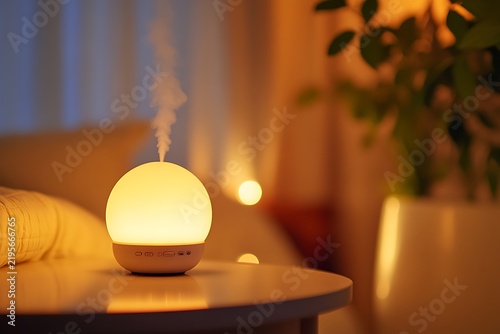 Illuminated Aroma Diffuser on Nightstand.