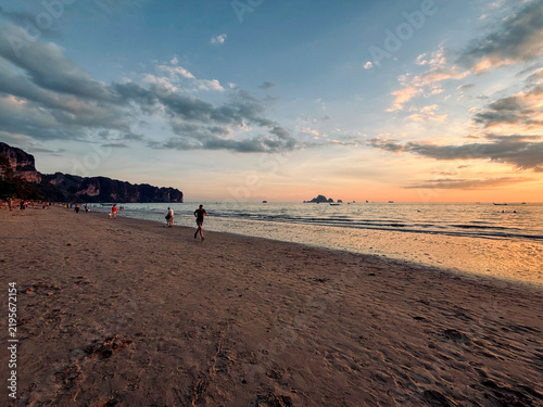 Dramatic Sunset at Ao Nang Beach with Silhouetted People, Krabi, Thailand