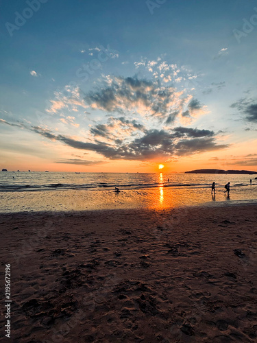 Dramatic Sunset at Ao Nang Beach with Silhouetted People, Krabi, Thailand