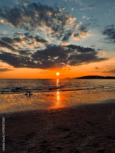 Dramatic Sunset at Ao Nang Beach with Silhouetted People, Krabi, Thailand