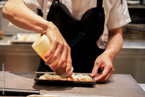Professional Sushi Chef Preparing Fresh Traditional Japanese Sushi in a Restaurant Kitchen