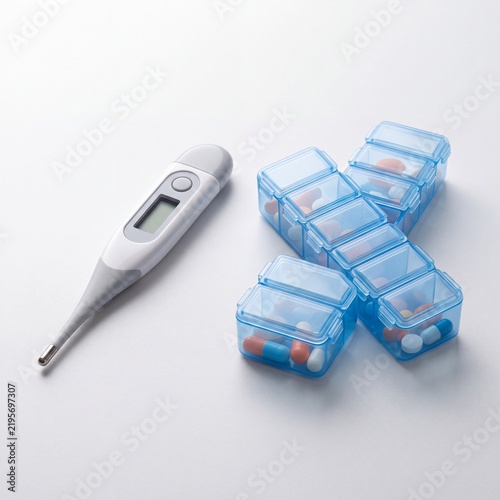 Digital thermometer and blue pill organizer with medication