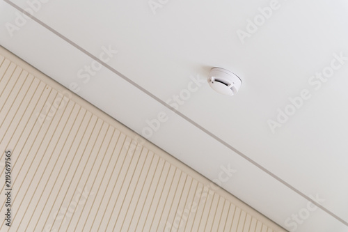 Smoke detector mounted on a white ceiling