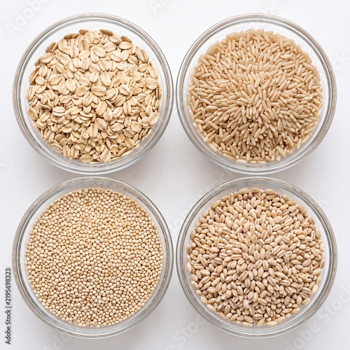 Varieties of healthy whole grains in glass bowls