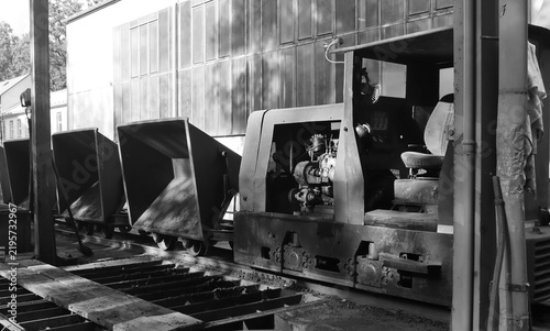 Black and white photo of industrial mining locomotive train.