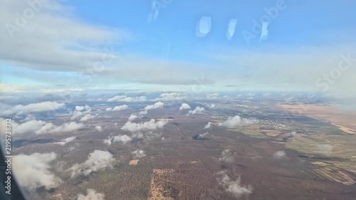 Passenger window view over Austrian countryside approaching Vienna International Airport.