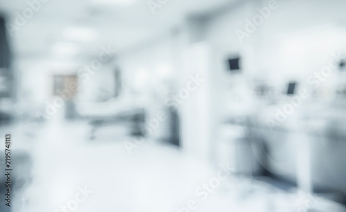A blurred interior of a hospital or clinic depicting medical equipment and a sterile environment, conveying a sense of healthcare and healing.