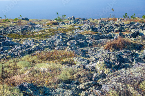 Mountain landscape with rocks and grass on the foreground. Northern Urals, Russia