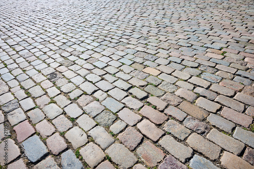 Background created using a close-up of a surface paved with rectangular stones.