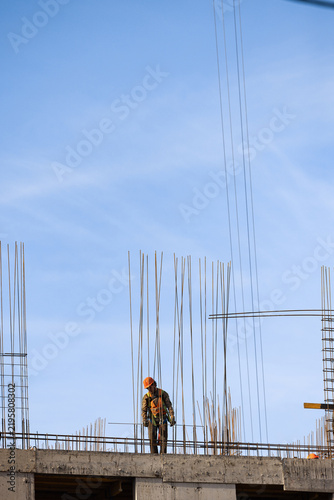 American construction worker stands under wide sky with copy space