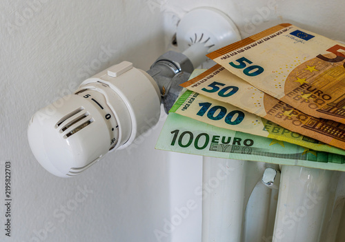 euro bankonotes on radiator. heating price increase. money consumption for heat. expensive winter season. european civil energetic