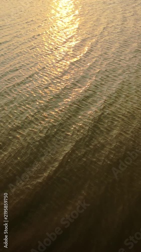 Golden Sunset Reflections on Water Surface