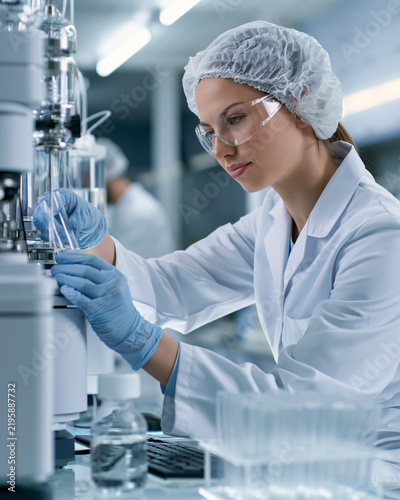 Scientist monitoring protein purification equipment in biotech lab