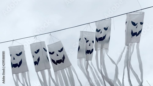 Spooky scary ghosts monster faces lanterns waving on wind on halloween background,autumn holidays,decoration and party concept.