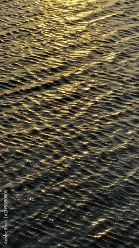 Golden Sunset Reflections on Rippling Water