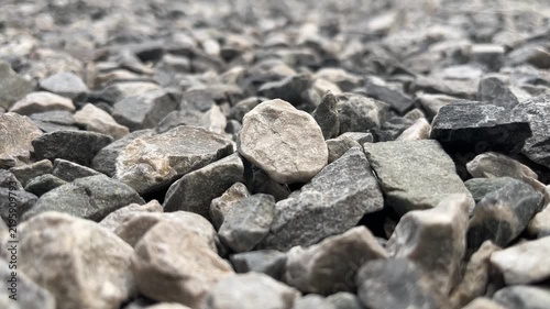 Gravel Texture Close-up: A macro view reveals the intricate textures and varied shapes of a gravel surface, showcasing the rough, natural beauty of stone aggregate.