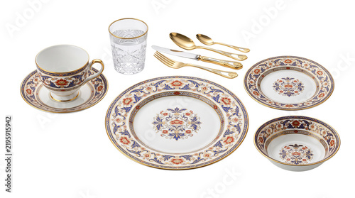 Elegant vintage porcelain dinnerware set, luxury ceramic tableware with gold cutlery, ornate blue and orange floral pattern dinner service isolated PNG with Transparent Background