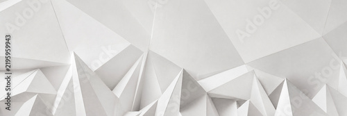 Minimalist white geometric background with 3D low poly paper texture. Abstract architectural relief with sharp triangular peaks and soft shadows. Modern clean aesthetic for web banners.