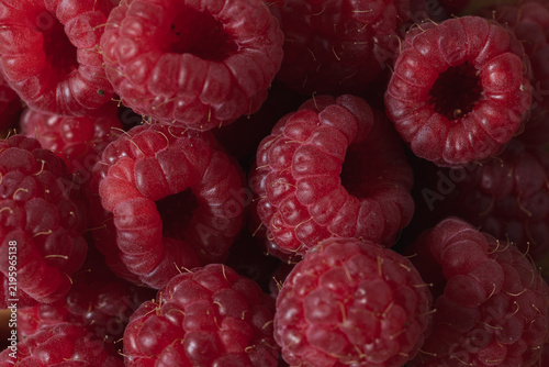 Close up of fresh raspberries creating a vibrant berry background, natural red fruit texture and fresh summer food backdrop