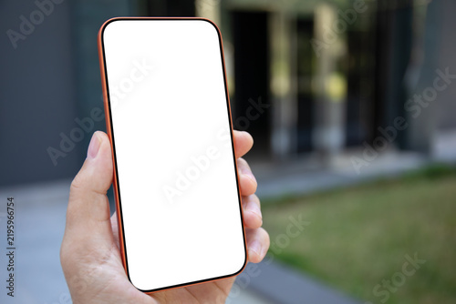 Man hand holding phone white isolated white screen mockup outdoors