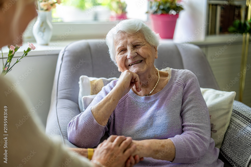 Obraz premium Elderly woman with her caregiver in nursing home 