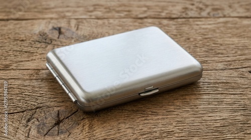 Sleek Metal Case Resting On A Rustic Wooden Surface