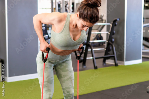 Determined woman passionately executing demanding strength building workouts at gym