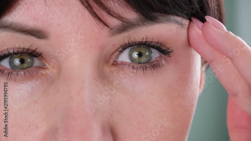 The woman has a drooping eyelid
