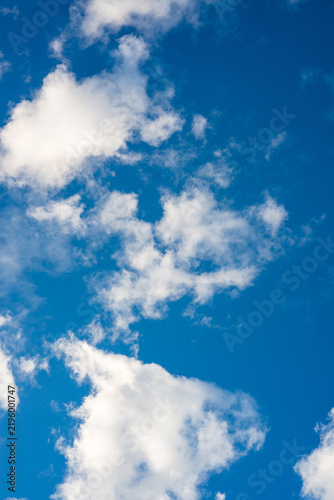 Fluffy White Clouds Floating Across a Clear Blue Sky