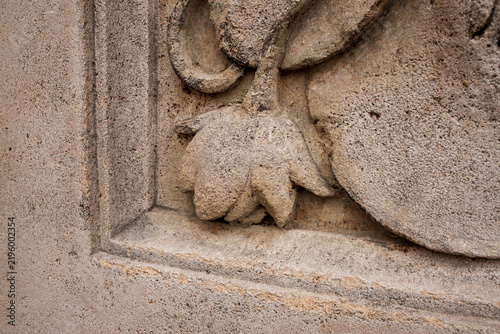 Weathered Stone Architectural Relief with Decorative Flower Carving