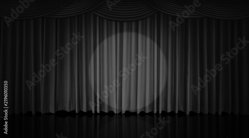 A black curtain hung on the theater stage, illuminated by spotlights.