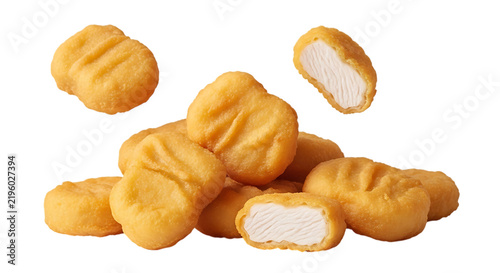 Crispy golden brown chicken nuggets piled together with some floating in the air, showing the breaded texture and white meat inside isolated on a transparent background