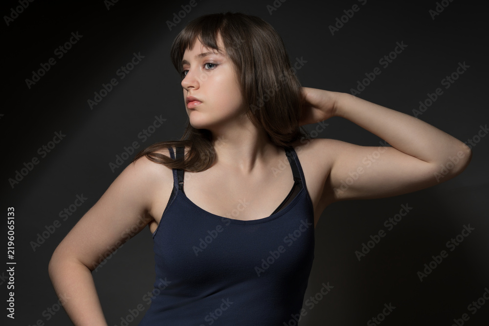 Fototapeta premium Beautiful teenage girl posing in beauty style on dark background