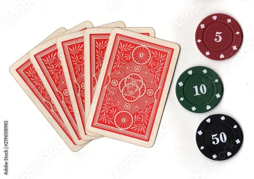 Photography A hand of vintage playing cards with poker chips isolated on a white background