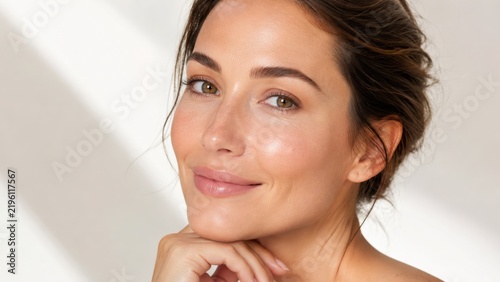Beautiful woman with natural makeup healthy glowing skin and shaped eyebrows in beauty portrait