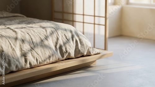 Oak platform bed with linen duvet and shoji grid shadows on concrete floor