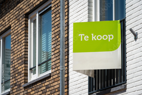 Housing market property listing with dutch text 'for sale' on modern house facade