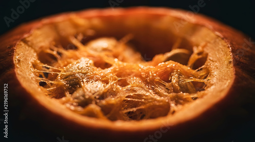 Close up of carved pumpkin interior showing fibrous pulp seeds and natural moisture