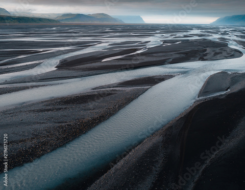Braided Glacial River Across Dark Volcanic Sand Plain