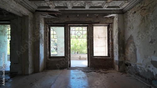 Walking shot going towards a covered balcony with a seaview on an abandoned villa