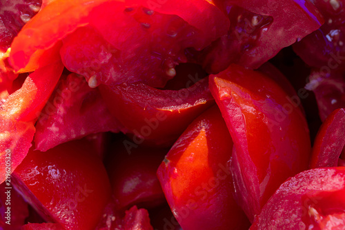 Ripe , sliced tomatoes prepared for tomato juice close up shot.