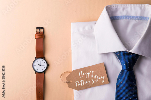 Folded Shirt with Tie and Mechanical Wristwatch on a Neutral Background for Father’s Day Mockup — AI-generated